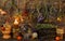 Still life with dry herbs, crystal ball, bottle and burning candle on witch table