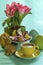 Still life with easter bunny, flowers, cup of coffee, candies and ceramic eggs
