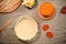 Still life. Flat lay. A rolled dough in a baking dish and fresh ingredients for making pumpkin apple Thanksgiving pie