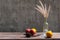 Still life with flower foxtail weed in glass bottles and fruits