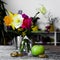 Still life of flowers in a vase, the composition of tulips and daffodils with Apple