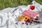 Still life and food photo. Cherry and waffle berries lie on a wicker round napkin and crumpled fabric