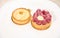 Still life with French baked tartlet with lemon meringue and partial view of raspberry cake, isolated white