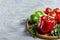 Still life of fresh organic vegetables on wooden plate over white background, selective focus, close-up