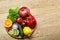 Still life of fresh organic vegetables on wooden plate over wooden background, selective focus, close-up