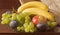 Still life.Fruit platter:bananas,grapes,Apple,plums