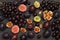 Still life of fruits. Bunch of grapes. Figs and plums. Cut figs, plum halves, plum pits