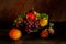 Still life with fruits: grape, apple, fig, pear on the antique copper tin plate