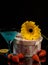 Still-life. Gift box, flower, cocktail glass, strawberry on a dark background