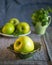 Still life with green apples and lemon balm