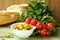 Still life of green marinated olives, herbs, tomatoes