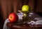 Still life green and red apples with metal dish and knife.