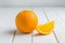 Still Life Half crescent, Full Fresh Orange Fruit on Vintage Whi