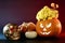 Still life for halloween golden skull with red eyes and jack o`lantern pumpkins