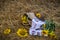 Still life of hats and baskets with sunflowers