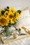 Still life in home interior of living room. Sunflowers, Coffee and open book. Read, Rest