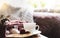 Still life Hot cuppa tea with steam with blurry foreground of toasted on a coffee table with morning light or Can be Cozy scene of