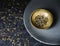 Still life image of a green tea hearbs on a golden bowl