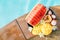 Still life image of tropical fruits and flowers near the pool: water melon, mango, mangosteen, passion fruit