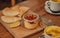 Still life inside a cafe with wooden tables and snack food. Appetizer hummus, pita bread and tea with lemon for lunch