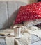 Still life interior details, cup of tea and book on the sofa