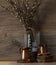 Still-life. Kitchen interior. copper measuring cups on wooden circles with willow branches on a wooden table