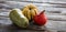 Still life of kuri squash and green gourd over wood