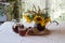 Still-life with kvass (kvas) in a transparent jug and a bouquet