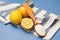 Still life of lemons, spoon with citric acid and striped napkin