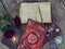 Still life with old decorated book with roses and crystals