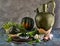 Still life with an old jug, Kabocha Squash, sprouts with olives and cheese on a gray background and a wooden stand