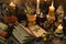 Still life with open book, four-leaf clover, candles and dry flowers on witch table