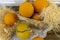 Still life with oranges, basket and glass jug with juice on old  wooden background