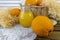 Still life with oranges, basket and glass jug with juice on old  wooden background