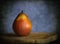 A still life of a pear on wood