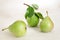 Still life with pears. Green fresh pears with leaves on light background.