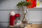 Still life: perennial plant in a glass vase, baseball ball on a candle