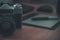 Still life of photographer desk in home office interior. Professional photo media working equipment, camera body, lenses