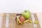 Still Life photography with two apples, tape mesaure and a scale