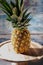 Still life of pineapple whole on wooden stand