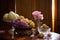 still life with plates full of fruits and flowers in vase on wooden background