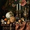 Still life with pumpkins, apples, garlic, dried flowers and candles