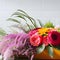 Still life shot of a variety of vibrant flowers arranged on a tabletop