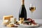 still life, with a sleek and elegant display of various cheeses, charcuterie, and a bottle of sparkling champagne