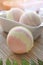 Still life spa resort treatment with bath bombs and candle on wooden background. Natural aromatherapy and relax concept.