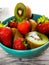 Still life of strawberries and kiwis on the table