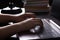 Still life of study or office at night under lamp light. Hands of young woman writer freelance typing on keyboard