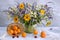 Still life with a summer bouquet, cherries and apricots