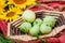 still life sunflowers and green apples in a basket.