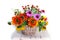 Still life with sunflowers and other flowers in a wicker basket on a white background